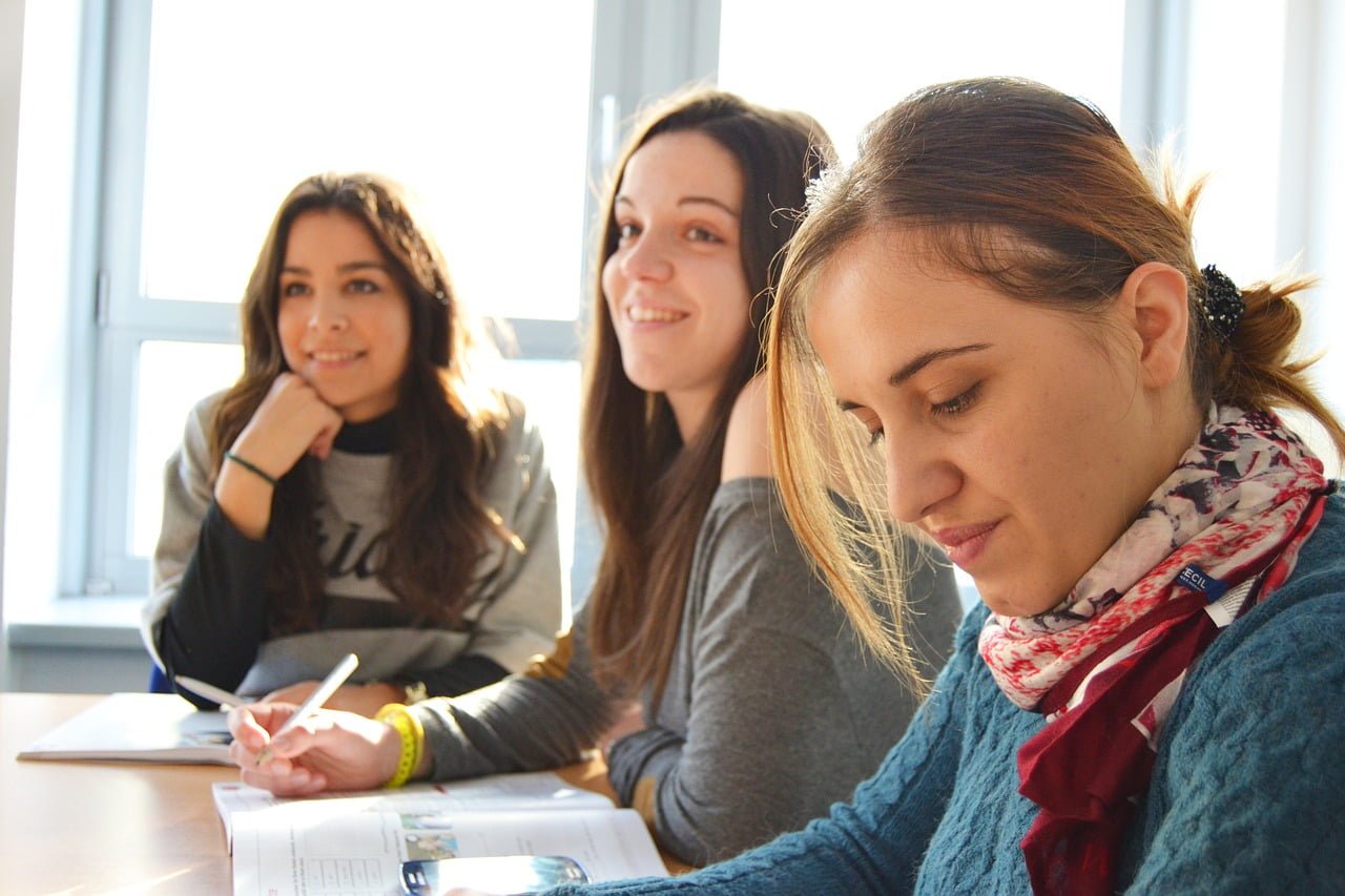 a group of women looking at a paper