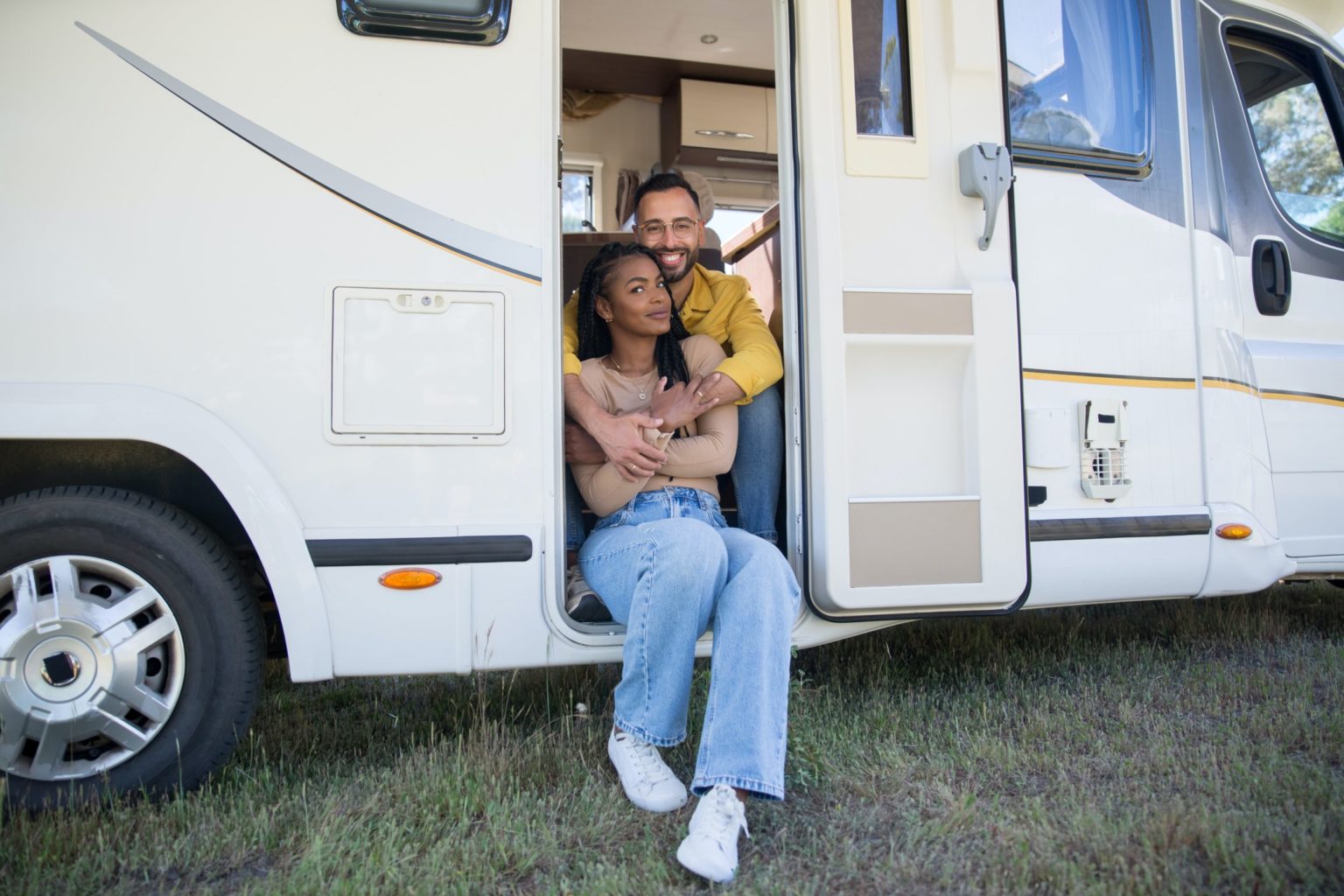 a man and woman sitting in a camper