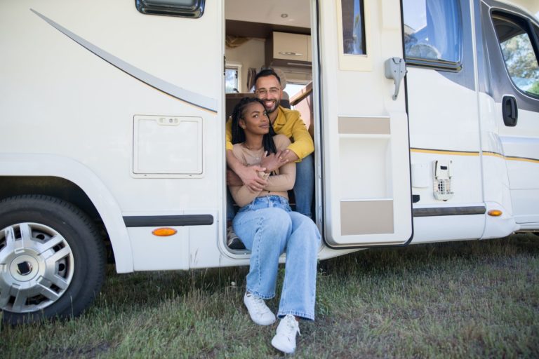 a man and woman sitting in a camper