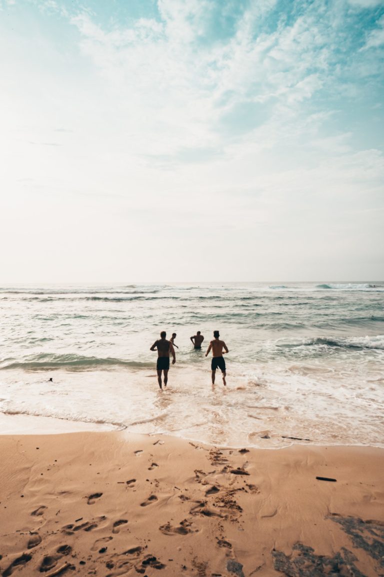 a group of people walking on a beach