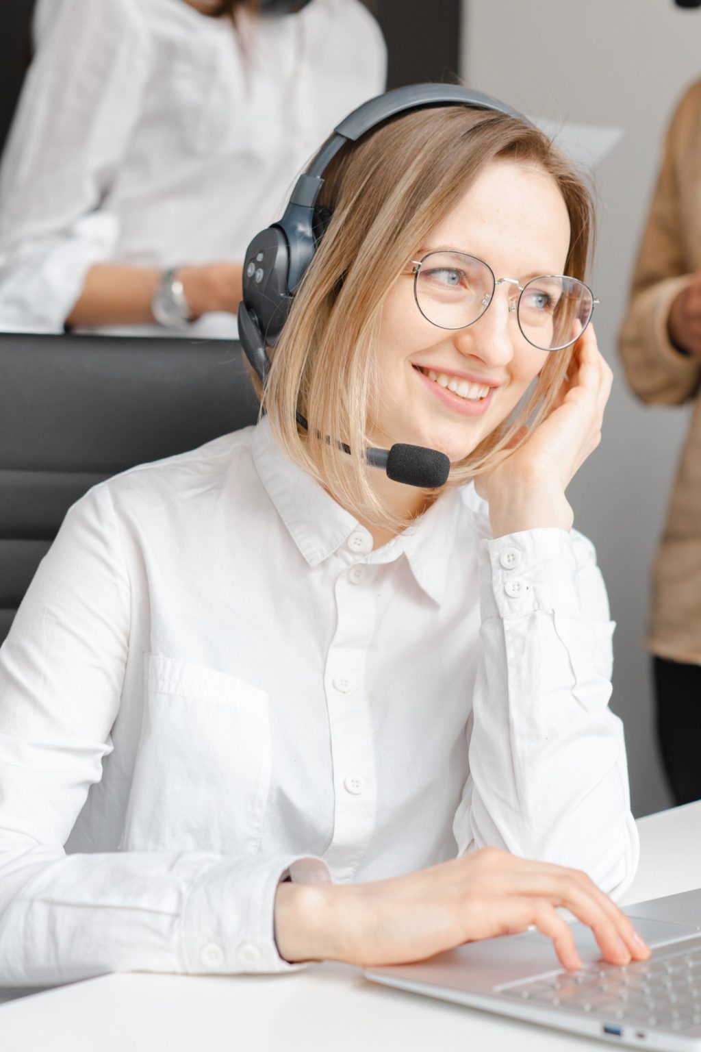 a person wearing headphones and sitting at a desk