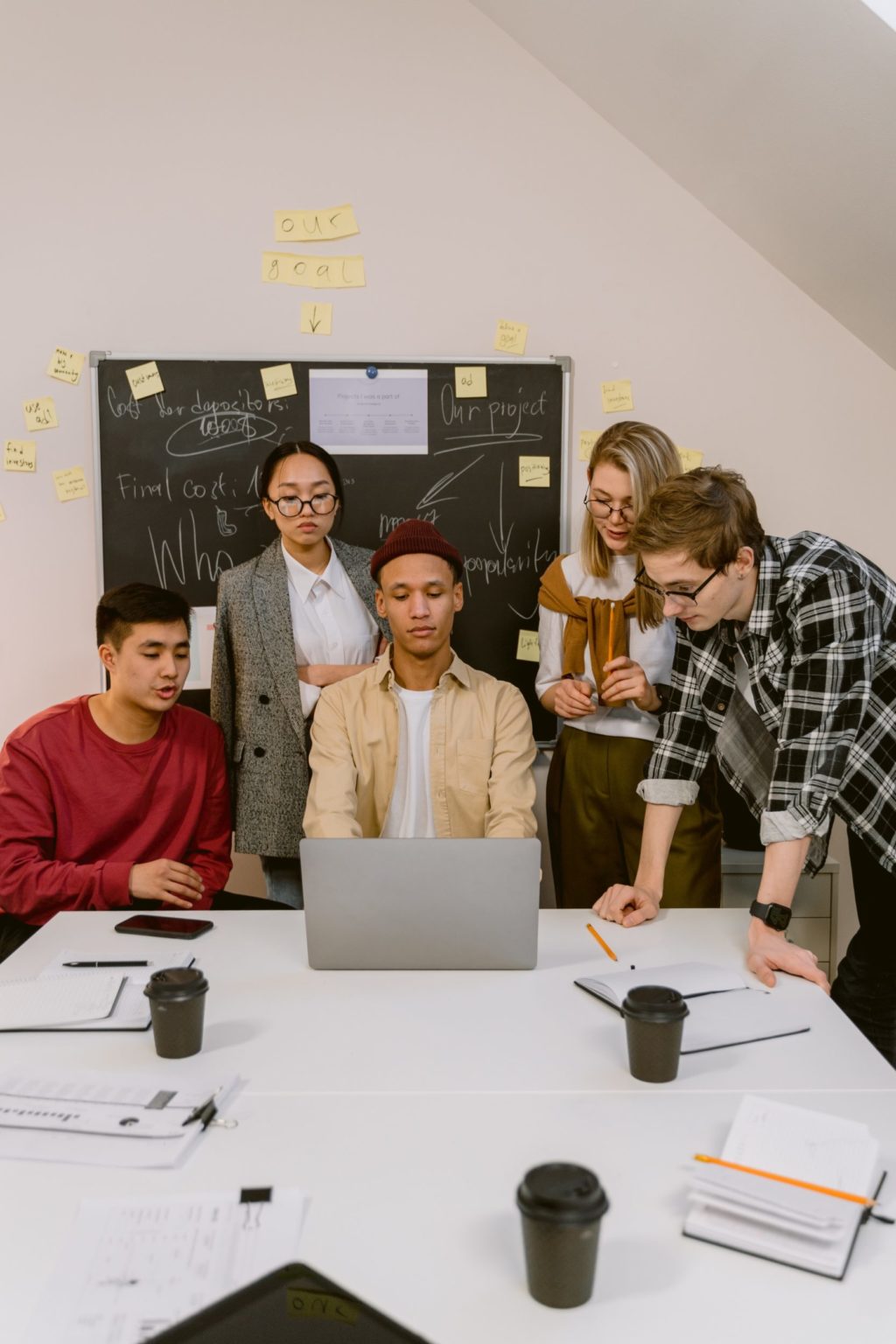 a group of people standing in front of a screen