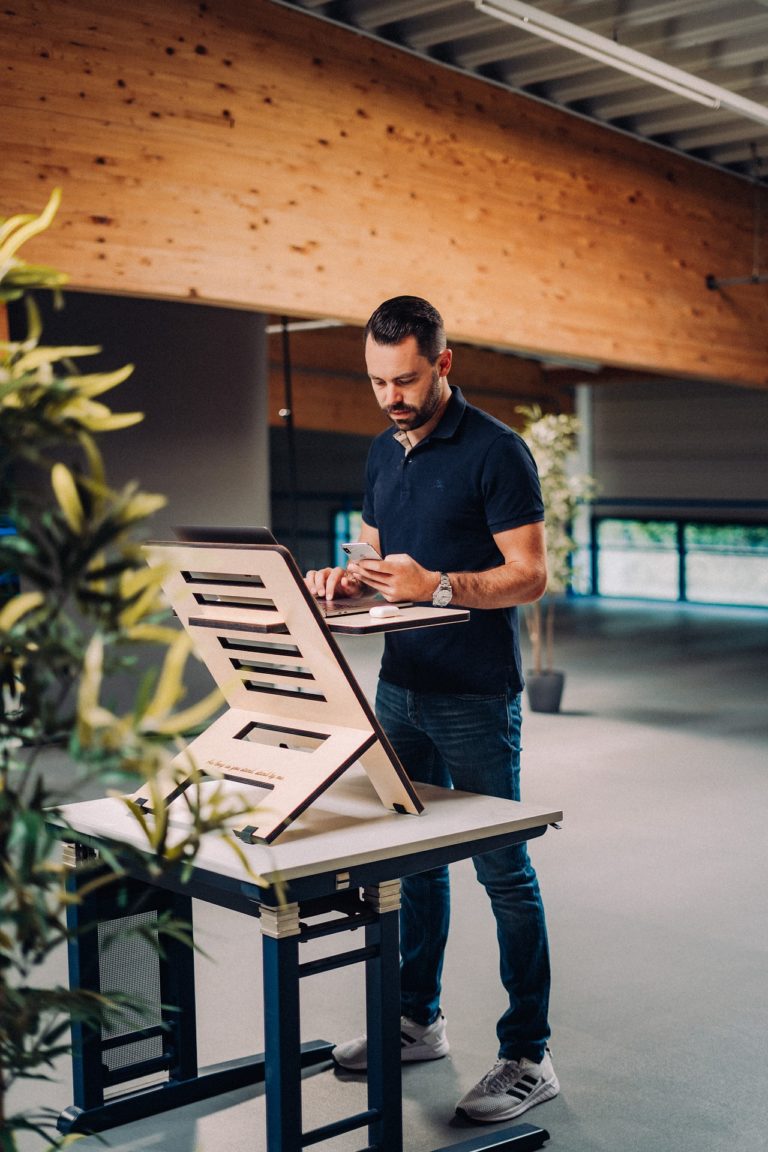 a man standing next to a piano