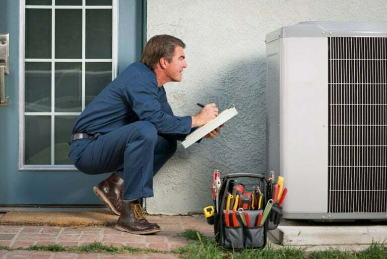 a man sitting on the ground holding a laptop