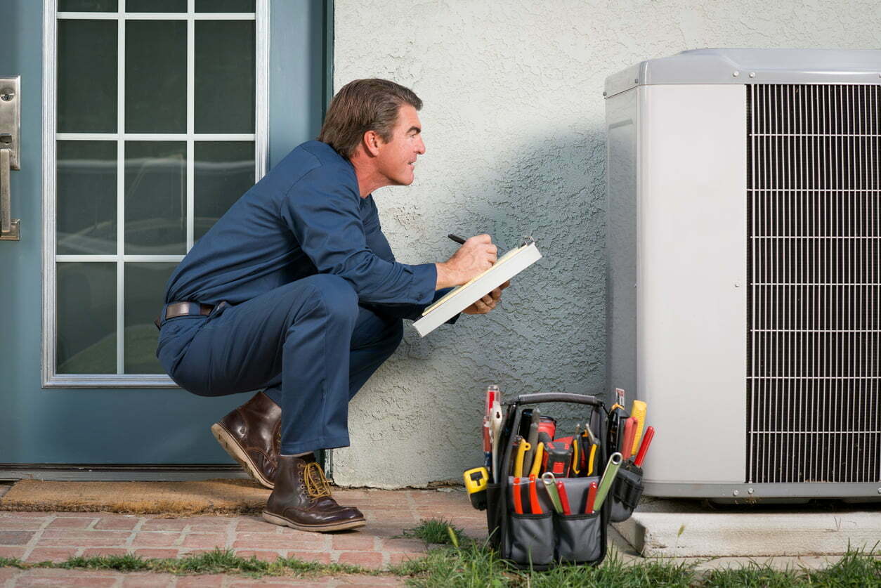 a man sitting on the ground holding a laptop
