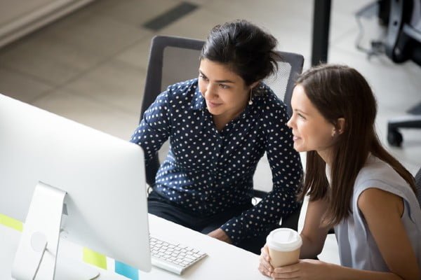 a man and a woman looking at a computer screen