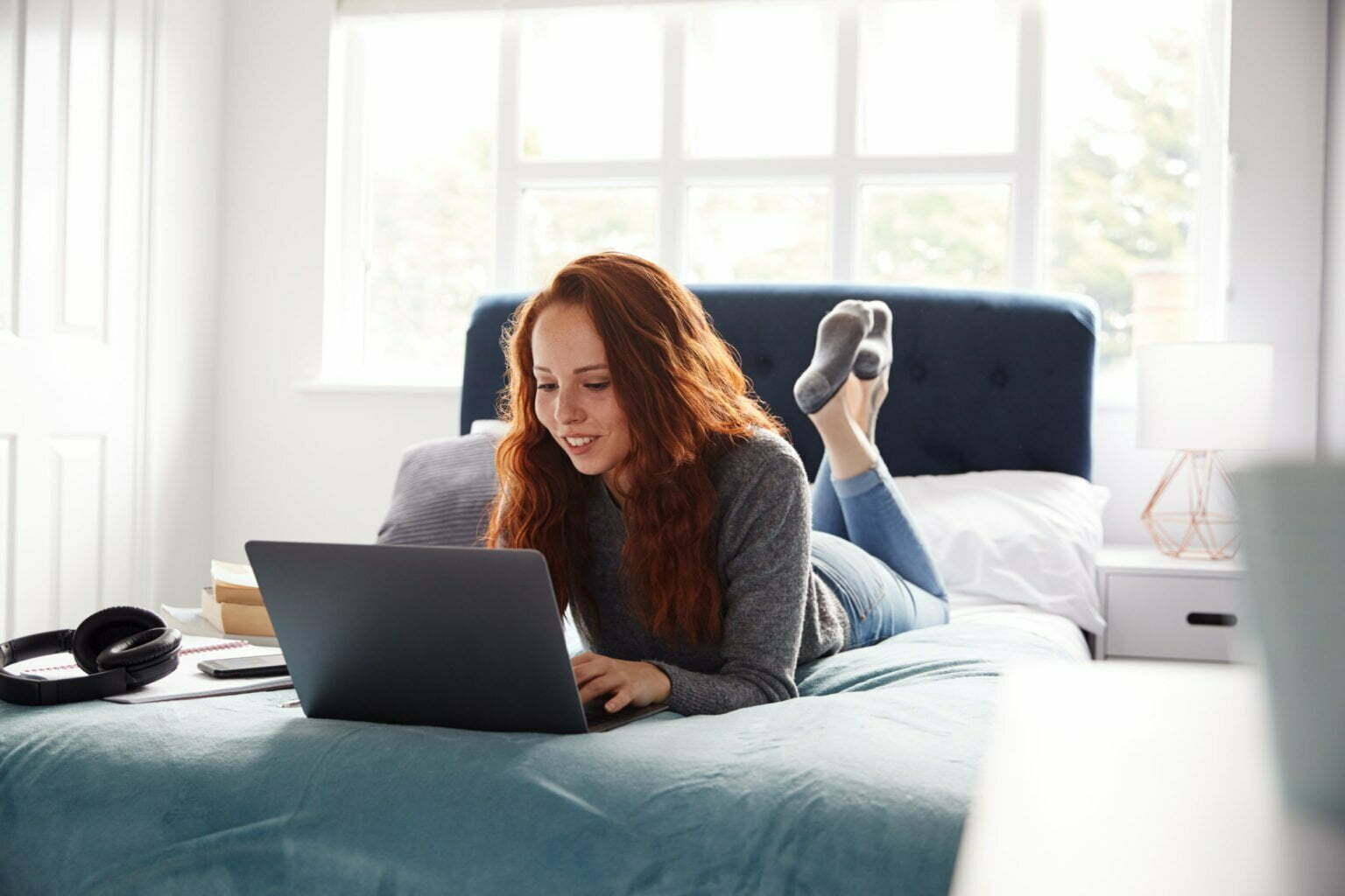 a woman sitting on a couch with a laptop