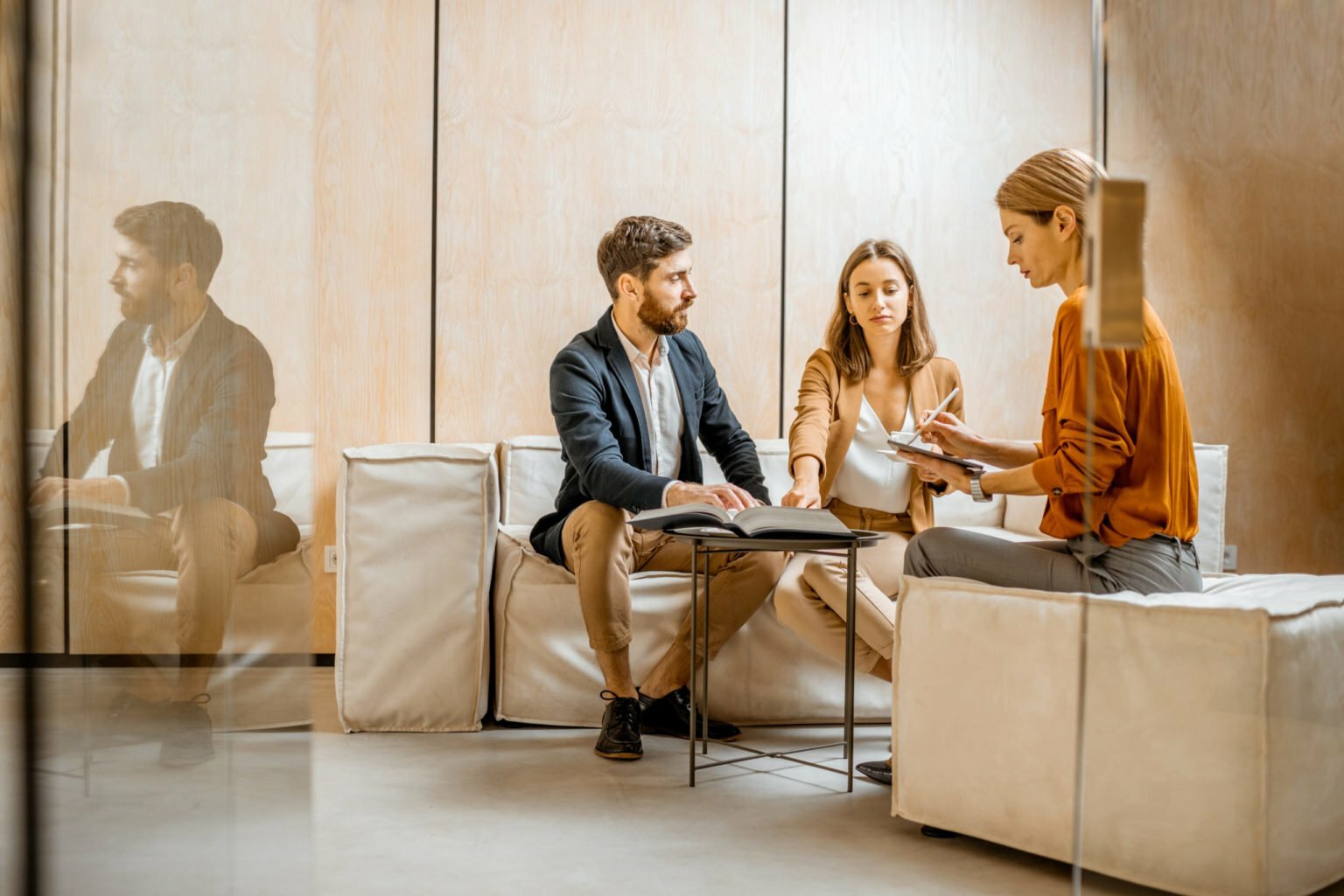 Young couple with sales manager in the office